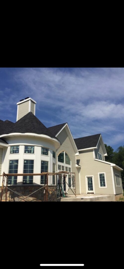 Modern house with large windows and chimney.