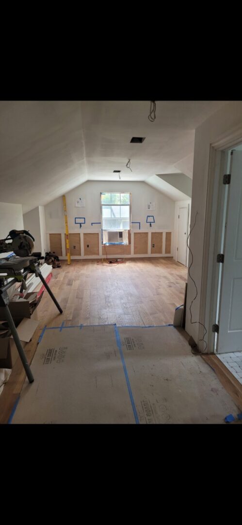 Unfinished room with wooden floor installation.