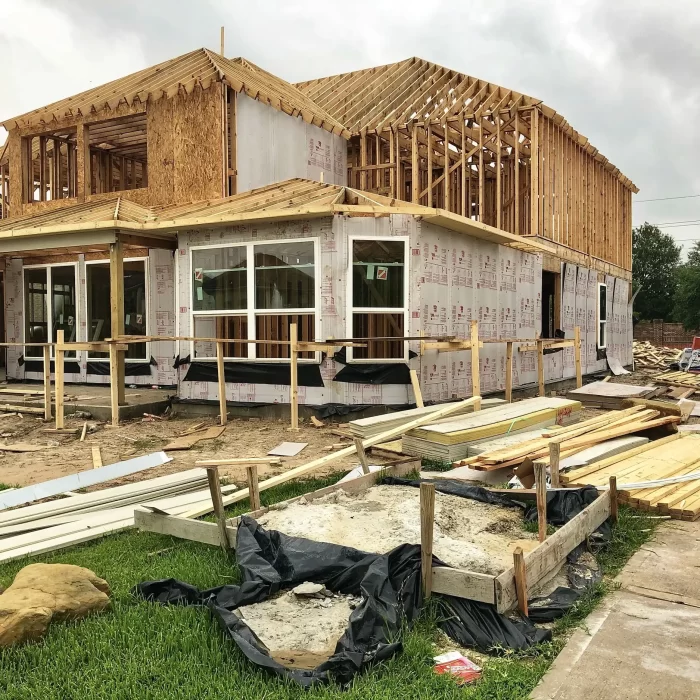 An image of wooden framed house that is under construction.